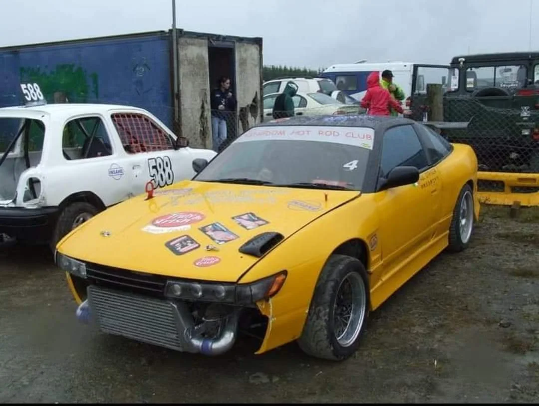 Yellow Nissan Silvia and a white race car in the owner's motorsport archive from Ireland