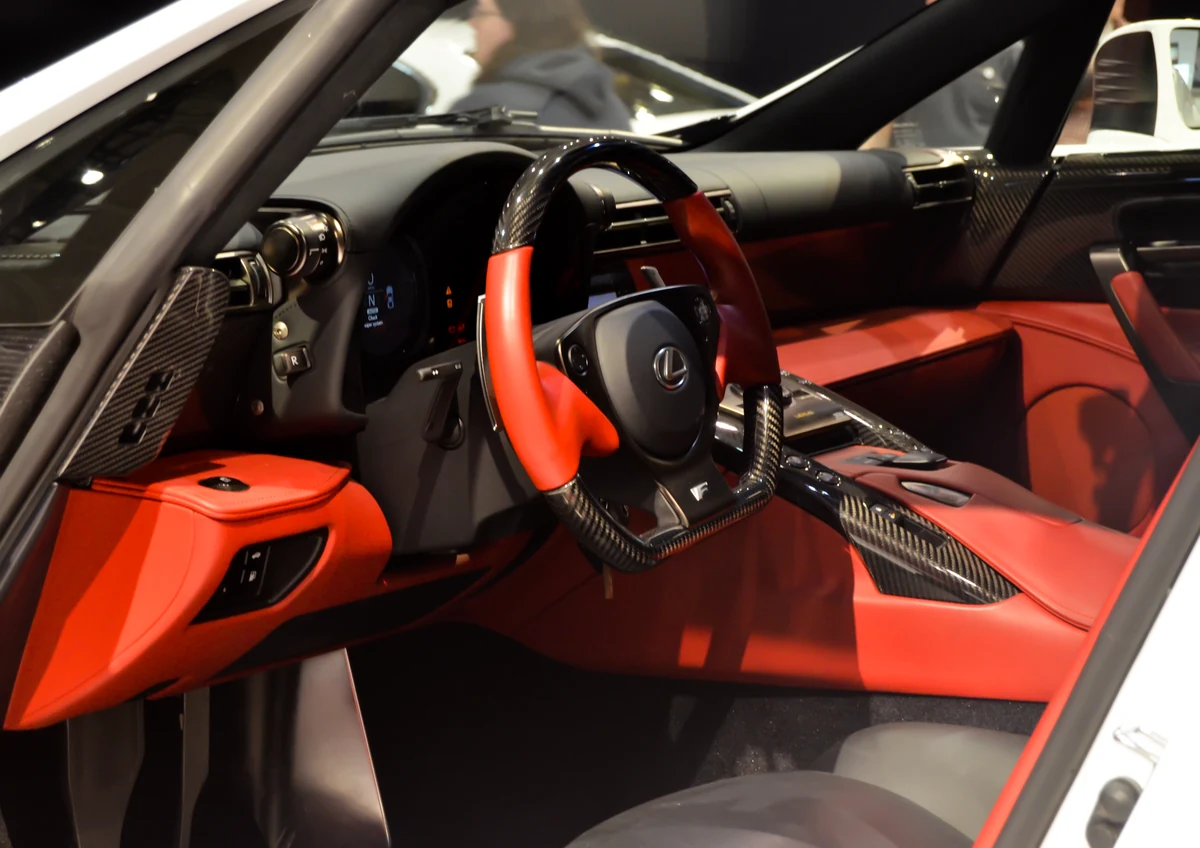 Red-and-black cabin of the original Lexus LFA, including steering wheel and centre console.